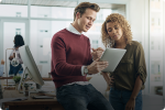 Two young people in an office examining a paper
